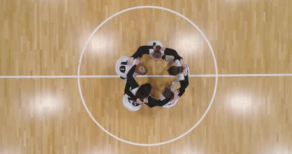 Group of Basketball Players Shouts Standing in an Embrace Raising Morale Before the Game the