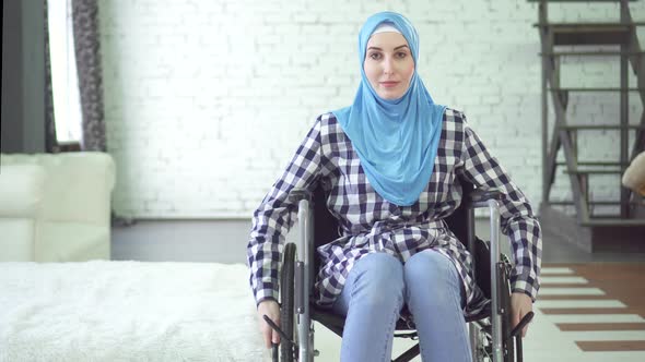 Beautiful Young Woman in Hijab Disabled Person Wheelchair in Apartment