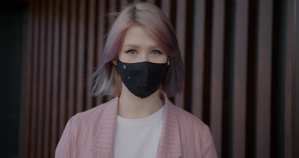 Slow Motion Portrait of Young Lady Wearing Multipleuse Fabric Face Mask Indoors