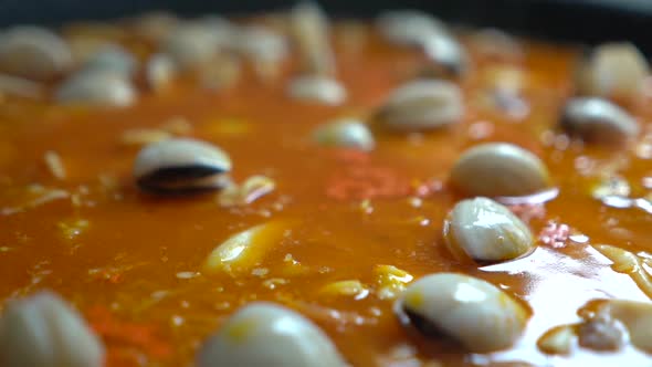 clams boiling in fish broth with saffron for fideua