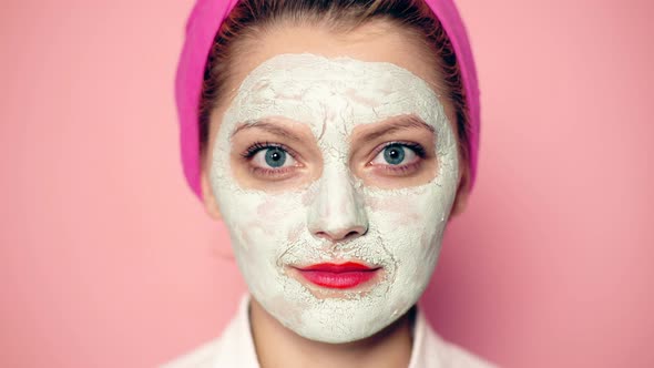 Close-up of a Girl with a Mask on Her Face with a Wide-open Eyes Smiling. Funny Girl with Cosmetic