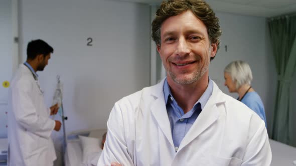 Portrait of a Caucasian male doctor working in a medical centre, wearing scrubs and a stethoscope, l