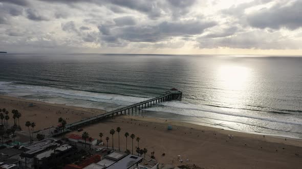 View of the seafront with a jetty at sunset, bird's eye view motion. Manhattan Beach, California