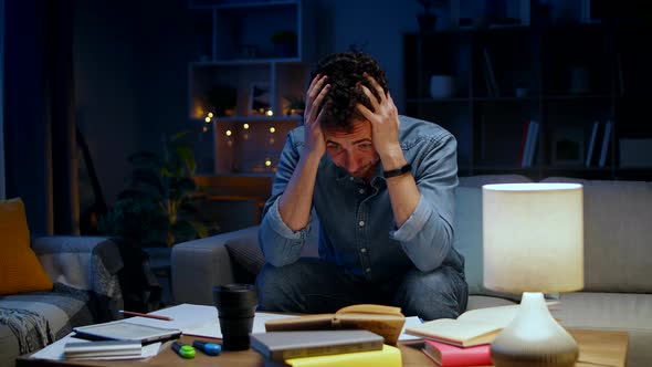 Young Man Tired While Studying at Home in the Evening