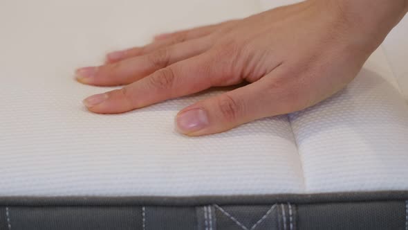 Woman is Choosing New Mattress for Good Sleeping