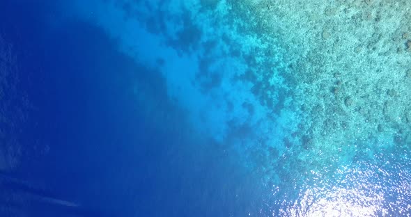 Beautiful above abstract view of a sandy white paradise beach and aqua turquoise water background in