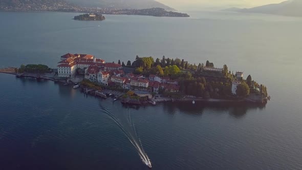 Boat Floats on the Lake From the Island at Sunset