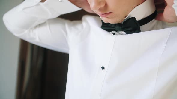 Morning of the Groom, Tying a Tie on a White Shirt.