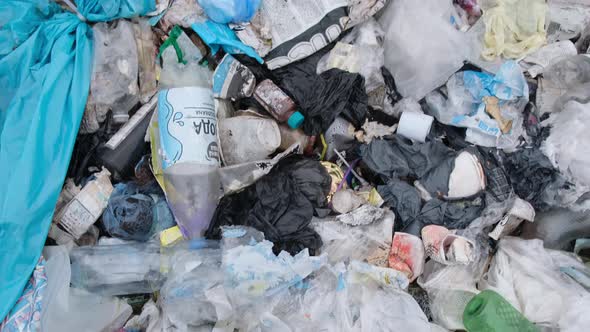 A Man Walks Through a Landfill an Environmental Disaster for Plastic Waste