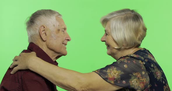 Elderly Man Hugging a Senior Woman and She Falls on His Shoulder. Chroma Key