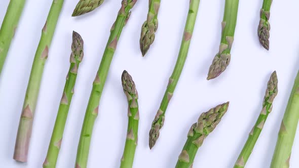 Rotating Green Fresh Asparagus on White Background Trendy Vegetable Background Healthy Food Concept