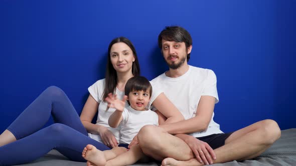 Family of Three People Mom Dad and Son Are Sitting at Home