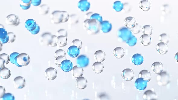 Super Slow Motion Shot of Blue and Transparent Hydrogel Balls Bouncing on Glass at 1000Fps