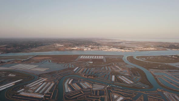 Aerial dolly out shot reveals the spectacular view of vast expanse of salt pans in Castro Marim.