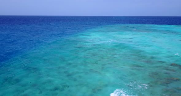 Wide angle aerial copy space shot of a summer white paradise sand beach and blue sea background in v