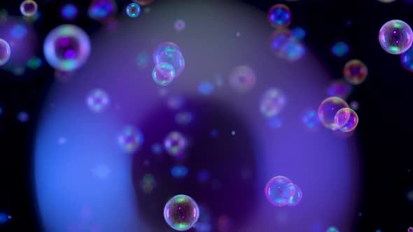 Blurred Footage of Beautiful Blue Rainbow Soap Bubbles Flying in the Air Against a Black Background