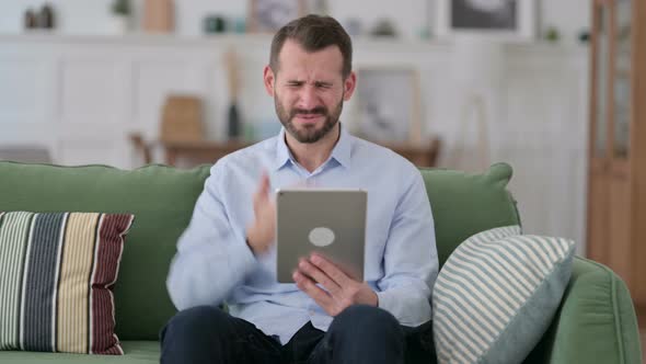 Young Man Reacting To Failure on Tablet