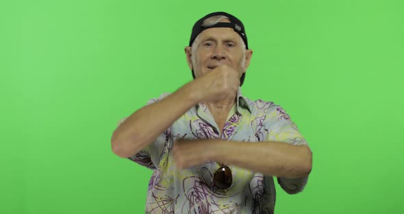 Senior Man Tourist in Colorful Shirt Dances. Handsome Old Man on Chroma Key