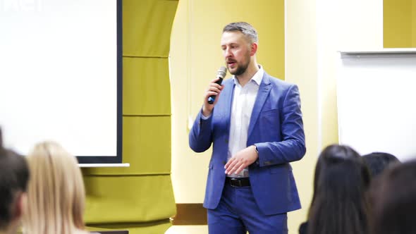 Businessman speaking at a podium in a conference or seminar