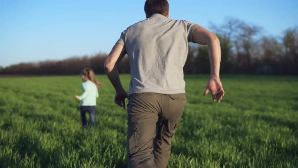 Happy Family Having a Rest on a Meadow on a Sunny Day