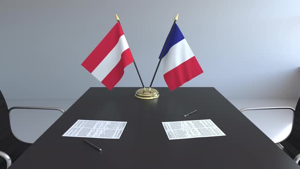 Flags of Austria and France and Papers on the Table