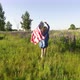 Woman Running With American Flag In Meadow - VideoHive Item for Sale