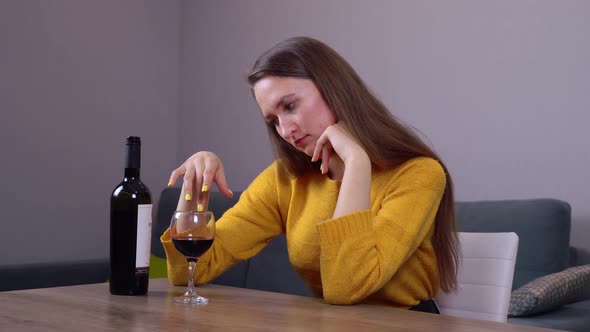Portrait of a young woman with a glass of red wine .