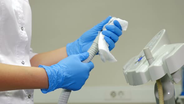 Dental Assistant Wipes Medical Devices and Tools with Disinfectant Solution. Processing, Cleaning