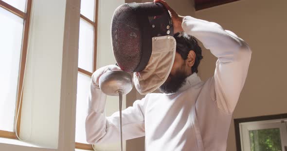 Fencer athlete during a fencing training in a gym