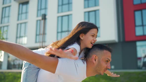 Loving Dad Play Piggybacking Daughter