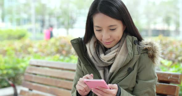 Woman use of mobile phone at park