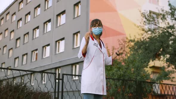 Funny Young Doctor Turns Around and Takes Off Medical Face Mask