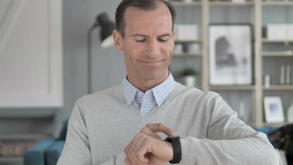 Middle Aged Man Browsing Internet on Smartwatch