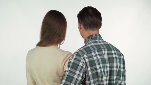 Rear View Shot of a Couple Hugging, Turning To the Camera Over Their Shoulders 1080p