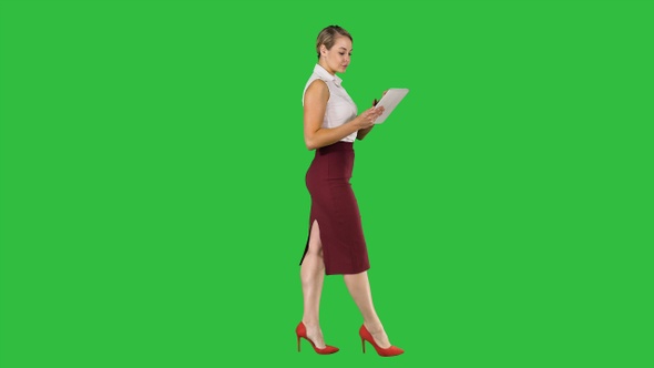 Businesswoman Using Electronic Tab Walking on A Green Screen