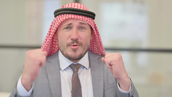 Portrait of Middle Aged Arab Businessman Dancing in Office
