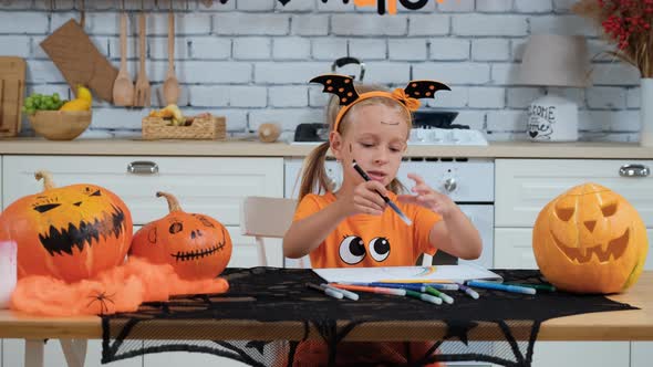 Cute Little Girl Drawing in Halloween