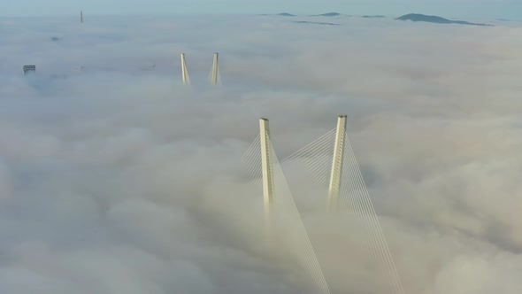 Tops of the Pylons of the Golden Bridge in the Dawn Fog in Vladivostok
