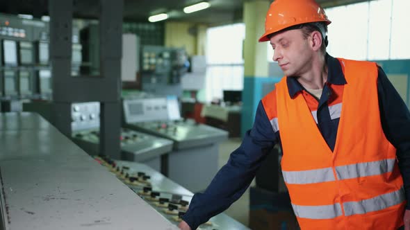 Engineer Wearing an Orange Protective Mask Hand Finger Press Button Controling