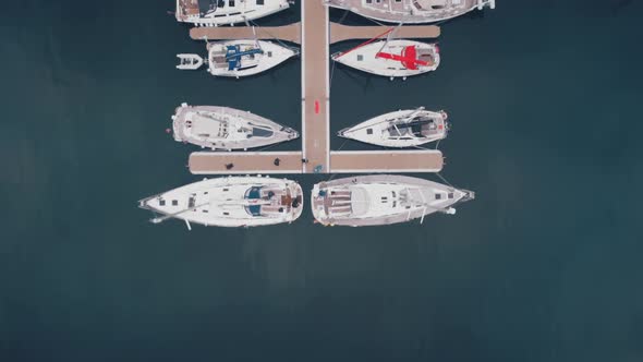 Top Down Slow Motion of Yachts Boats at Port Aerial