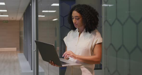 Businesswoman working on laptop in a modern office