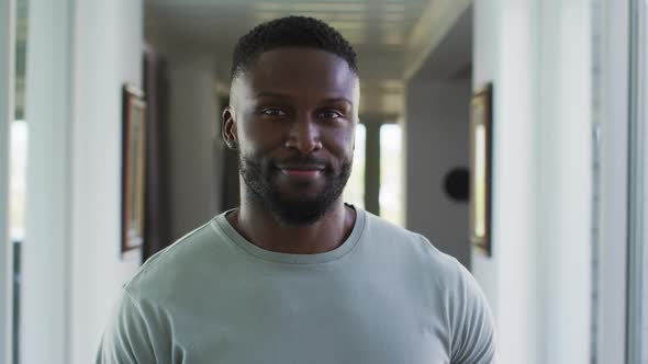 Portrait of african american man smiling while standing at home