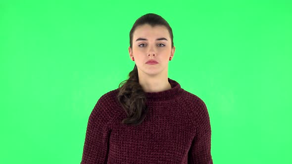 Girl Holding Paper Stick Expressing Awful Mood Then Takes Another Expressing Good Mood. Green Screen