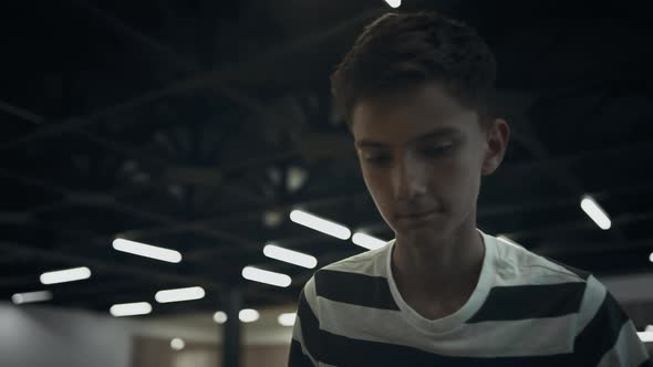 Portrait Focused Schoolboy Playing Table Football in School Campus Alone