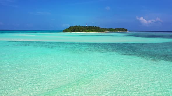 Aerial above seascape of tranquil seashore beach holiday by transparent sea with bright sand backgro