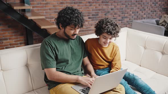 Indian Man Teaches Younger Brother to Use Laptop at Home