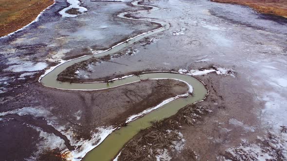 Muddy background. Dirty narrow stream of dried river. Ecological disaster. 