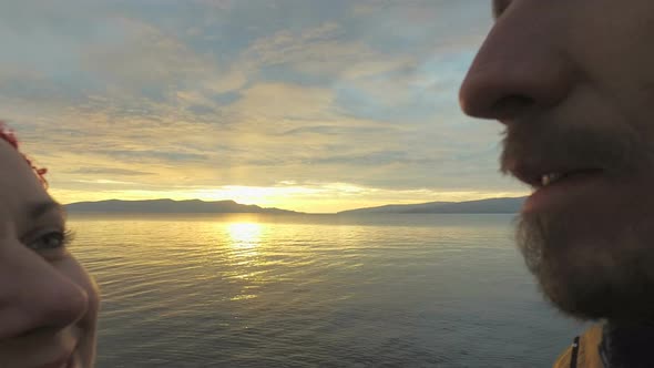 Couple kissing at sunset on at seaside