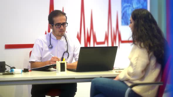 Doctor listening to patient in office