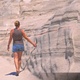 4K Woman hand touching eroded rock formation at Sarakiniko beach, Milos, Greece - VideoHive Item for Sale